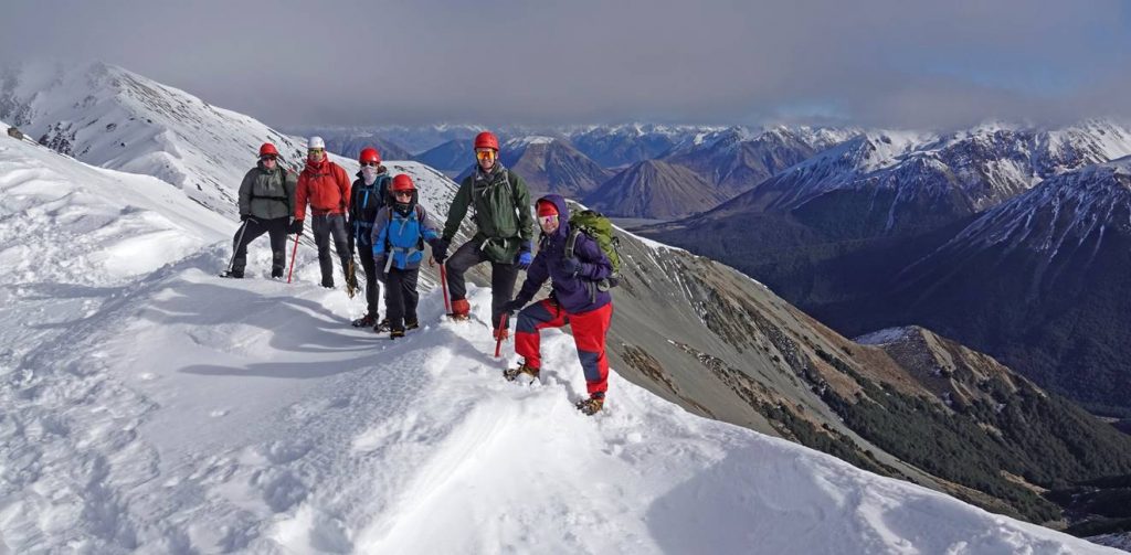 People on top of a mountain on an alpine consolidation trip