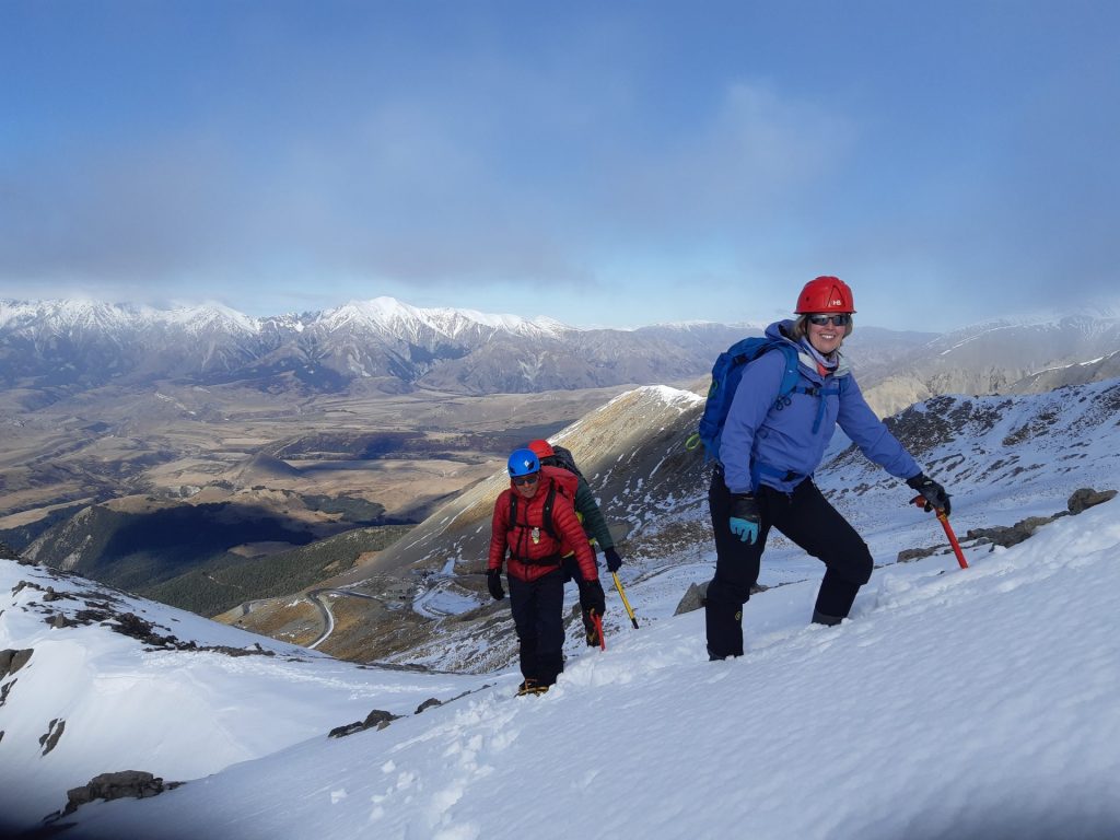People walking up a mountain on an alpine consolidation trip in New Zealand
