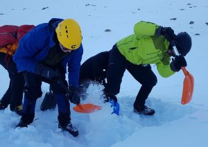 Digging on avalanche awareness course